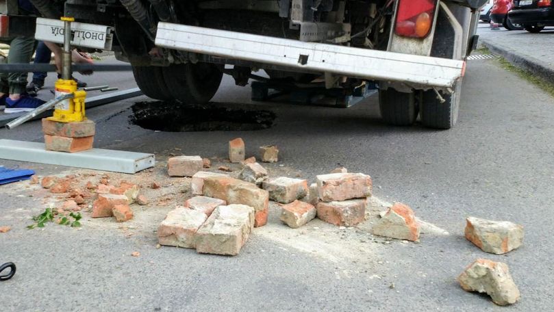 Un bărbat a intrat cu roata camionului într-o gaură formată în asfalt
