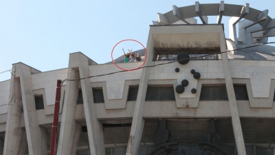 Se vede cum trei fete se află pe construcţie. Mai mult, acestea salută trecătorii, cu mâinile ridicate.
