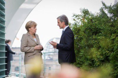O poză care-l înfăţişează pe fostul Premier alături de Angela Merkel pe fonul unor scări şi a unor tufari. Foto: tribuna.md