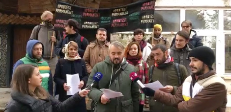 За спинами пикетчиков были расположены флажки с надписью "Постоянный протест".