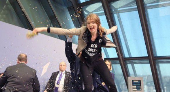 O femeie care s-a urcat pe masa unde Draghi susținea conferința de presă și a aruncat cu hârtii și confetti în șeful BCE. Foto: independent.md