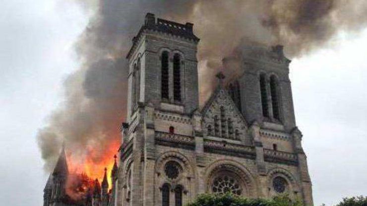 Пожарные пытаются сбить пламя с помощью брандспойтов.