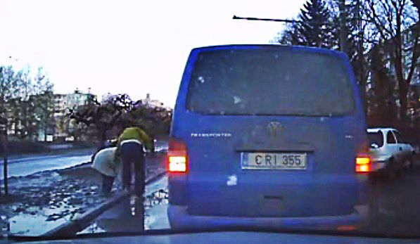Camera de bord a surprins momentul in care barbatul opreste masina, o pune pe avarii, si ajuta o batranica sa iasa din noroi. 