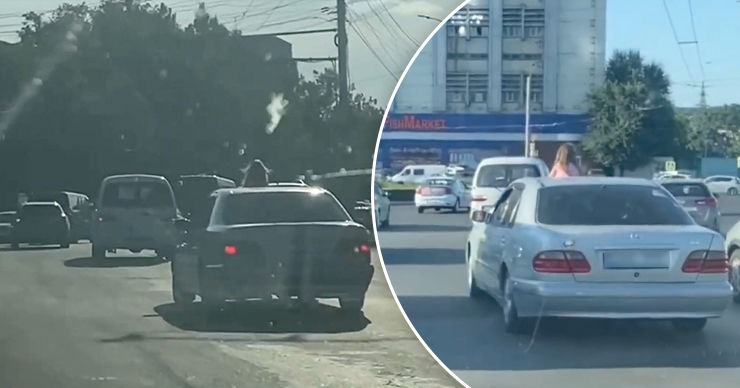 В столице девушка ехала, высунувшись из люка автомобиля.