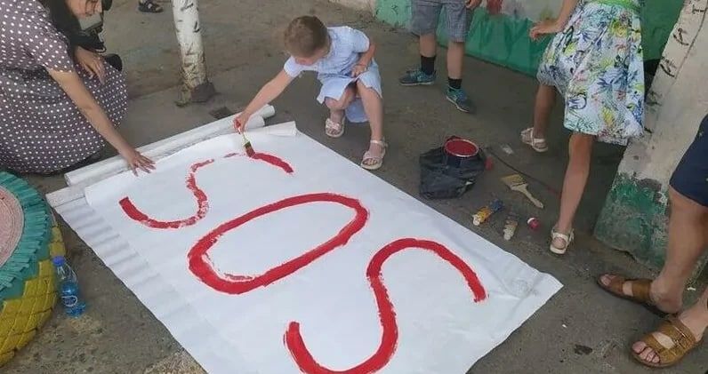 Жители падающего дома в России развесили в окнах плакаты "SOS"